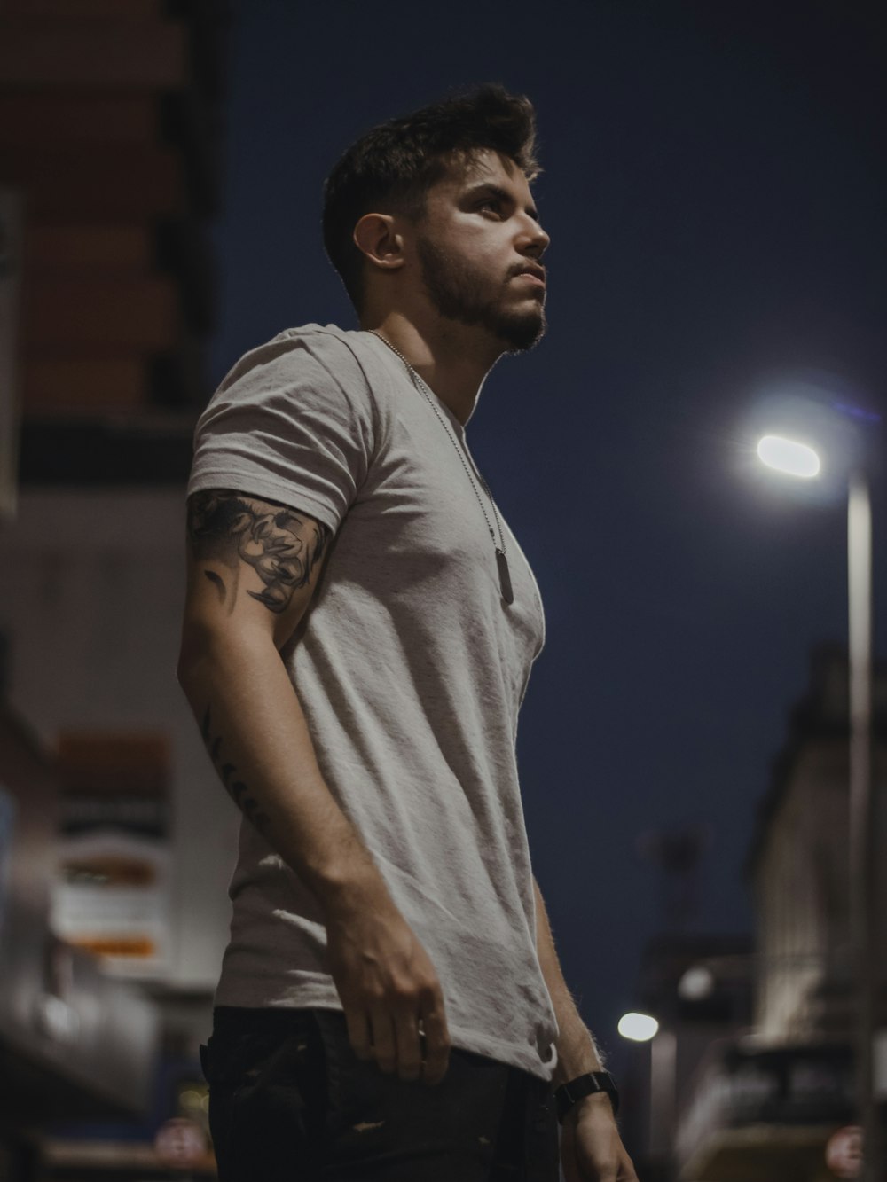 a man standing in the street at night