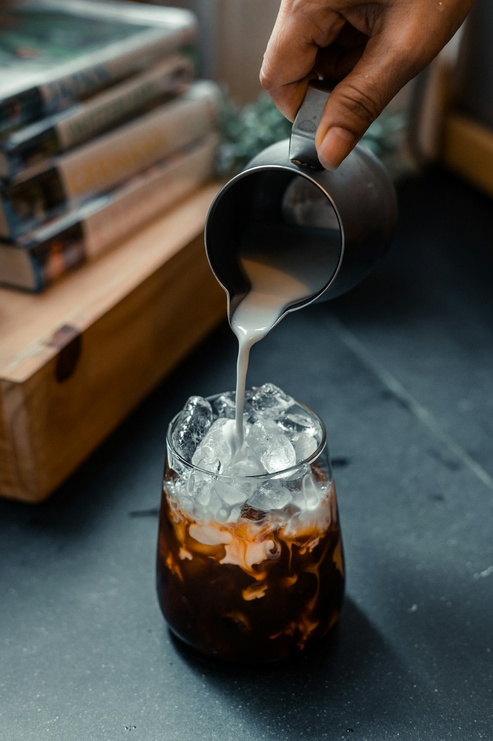 a person pours a drink into a glass