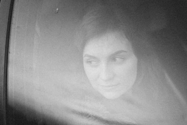 An atmospheric black-and-white photo capturing a thoughtful moment.