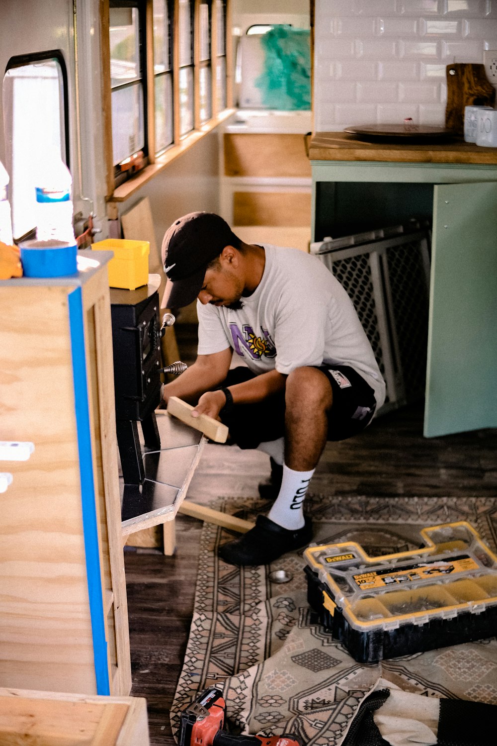 a man working on a stove in a kitchen