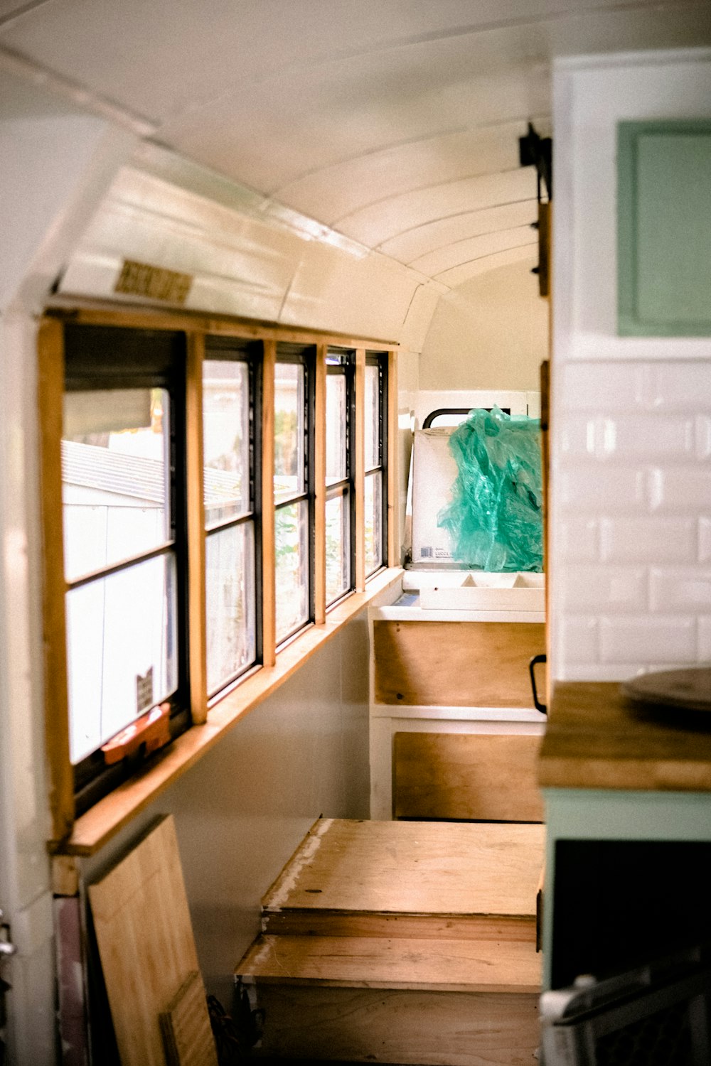 a view of a kitchen and stairs from inside a bus