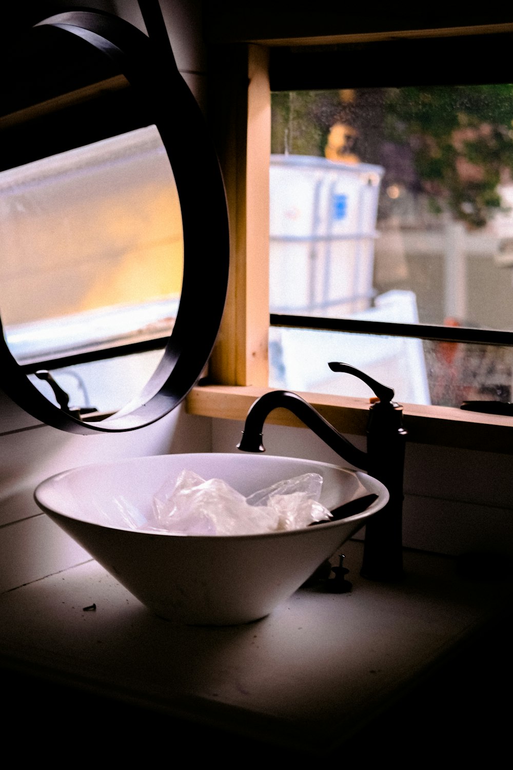 a white bowl sitting on top of a counter next to a window