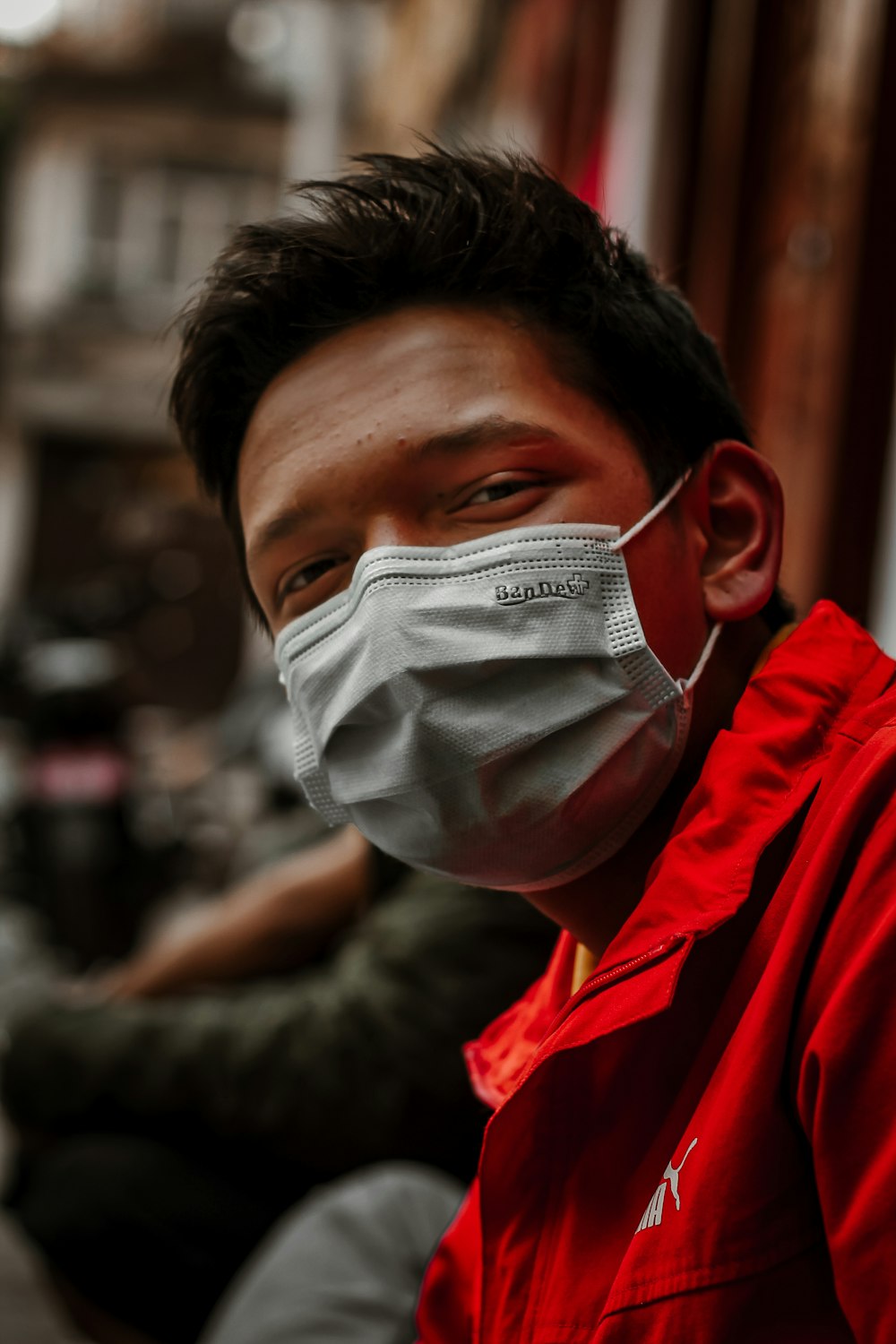 a man wearing a face mask on a city street