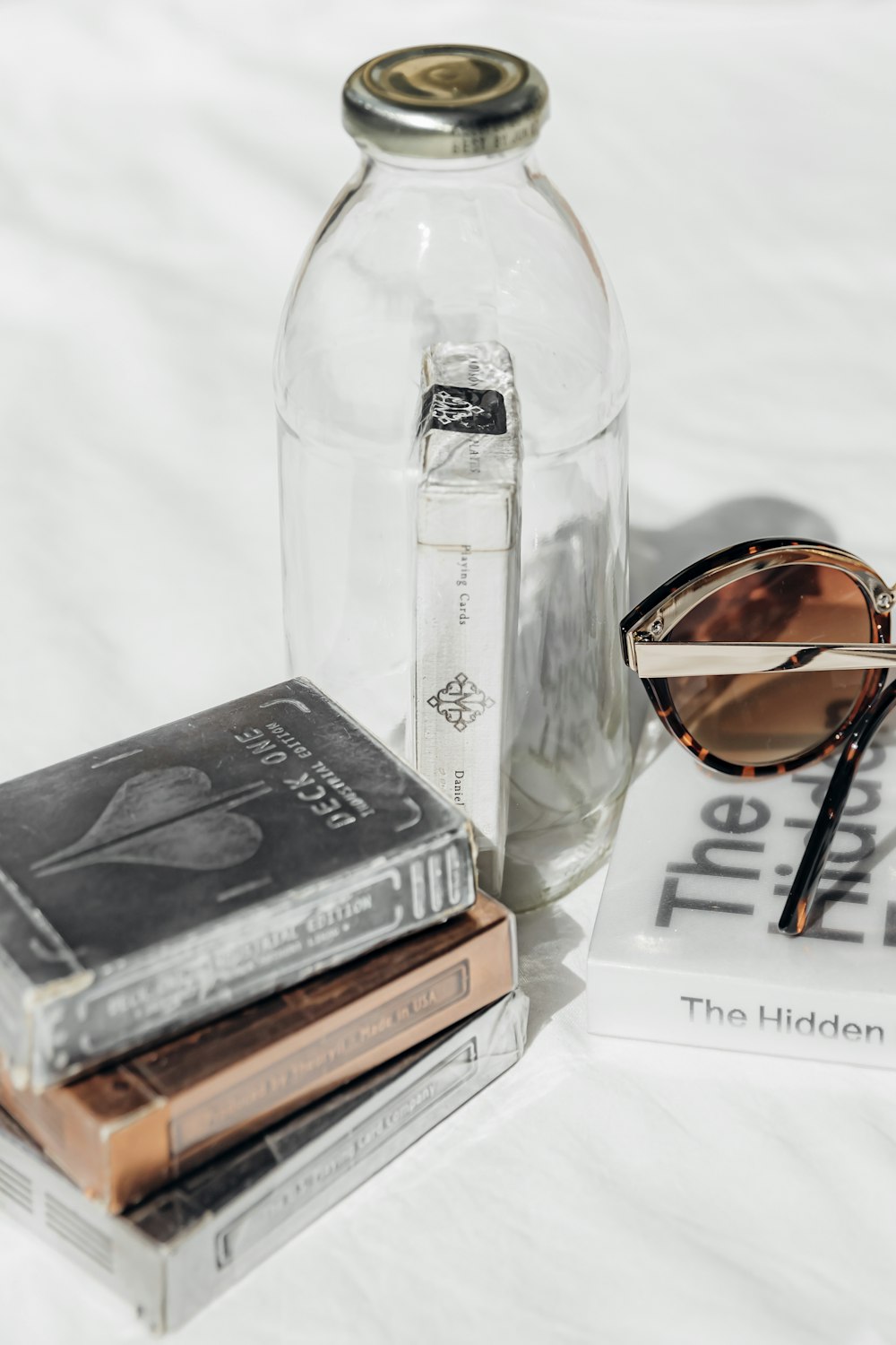 a couple of books and a pair of sunglasses on a bed