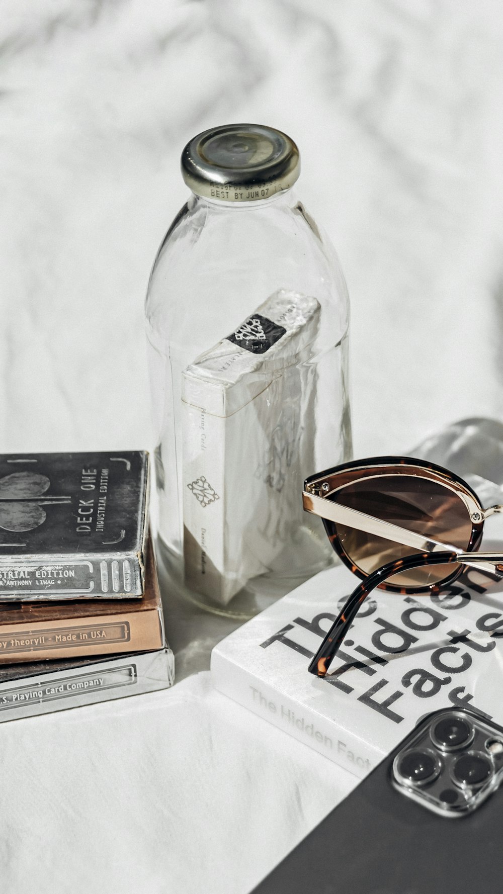 a table topped with books and sunglasses on top of a table