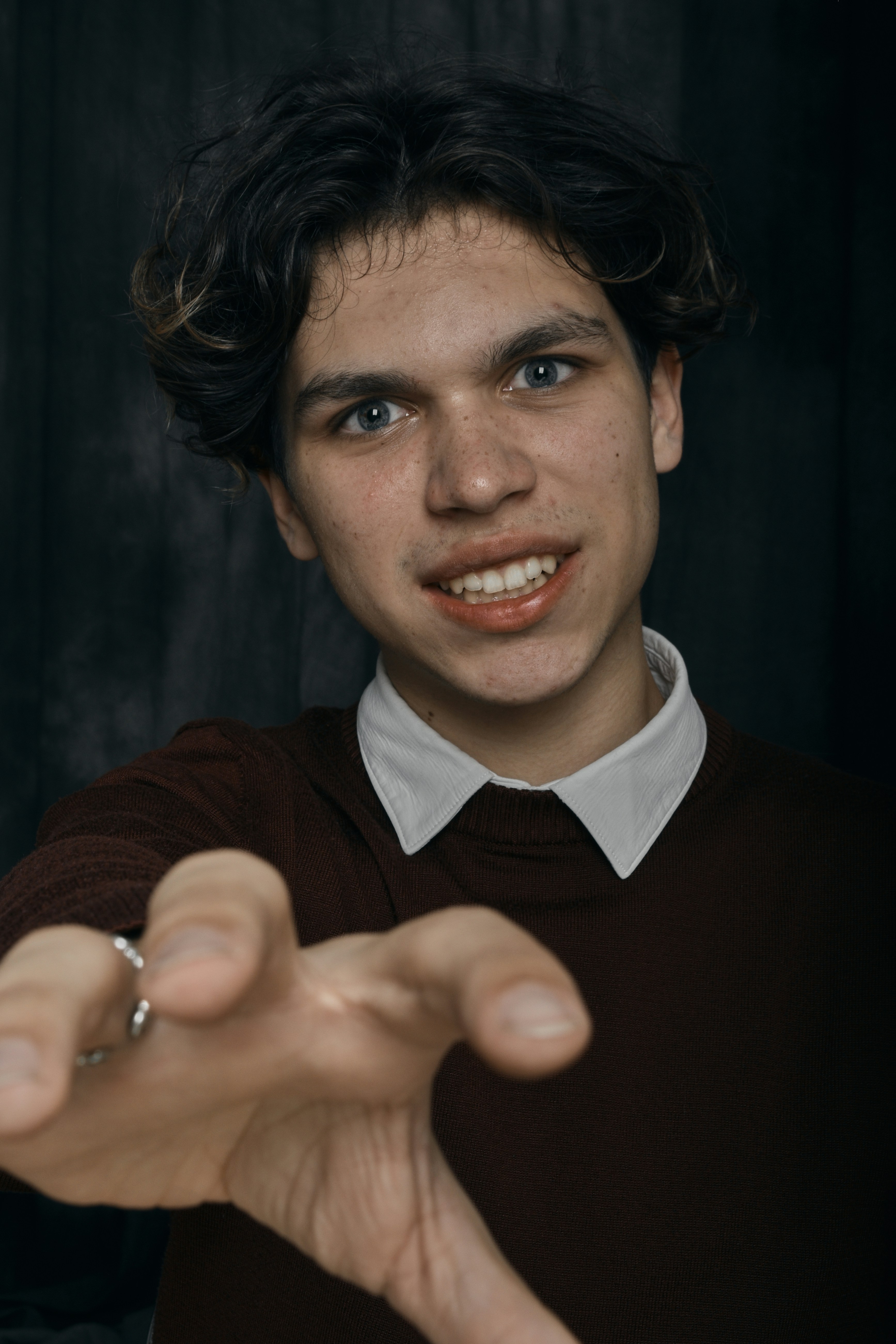 a young man making a hand gesture with his fingers