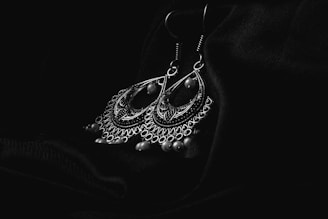 a black and white photo of a pair of earrings