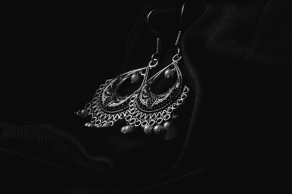 a black and white photo of a pair of earrings