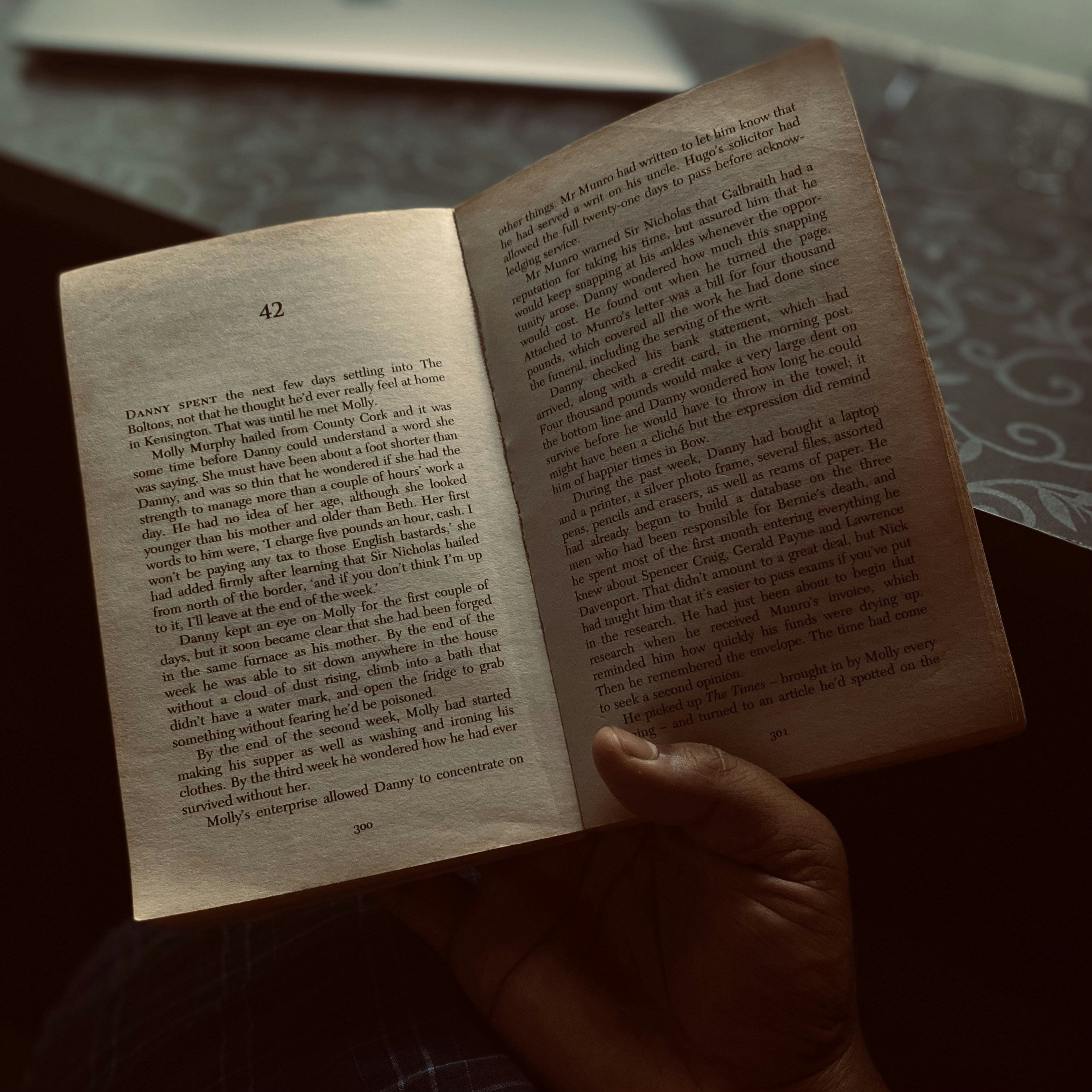 a person holding an open book in their hand