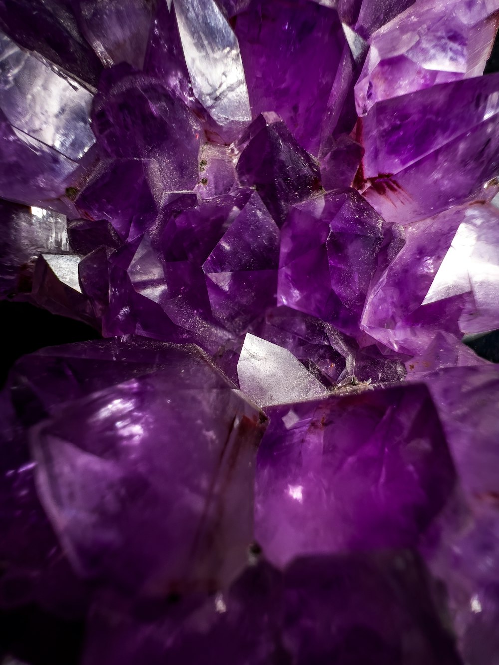 a bunch of purple crystals sitting on top of a table