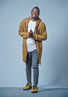 A friendly customer service representative wearing a branded tracksuit, smiling and ready to assist.