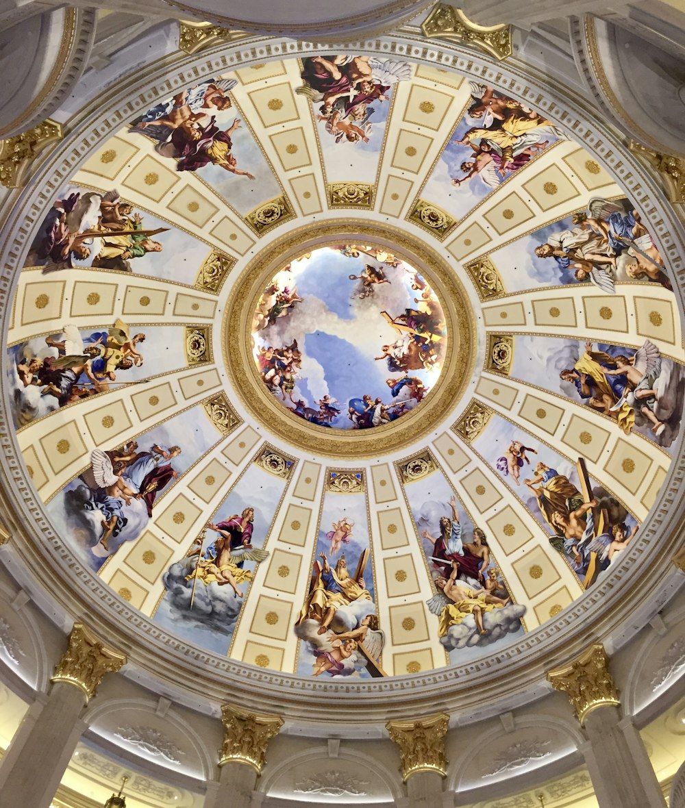 the ceiling of a building with paintings on it