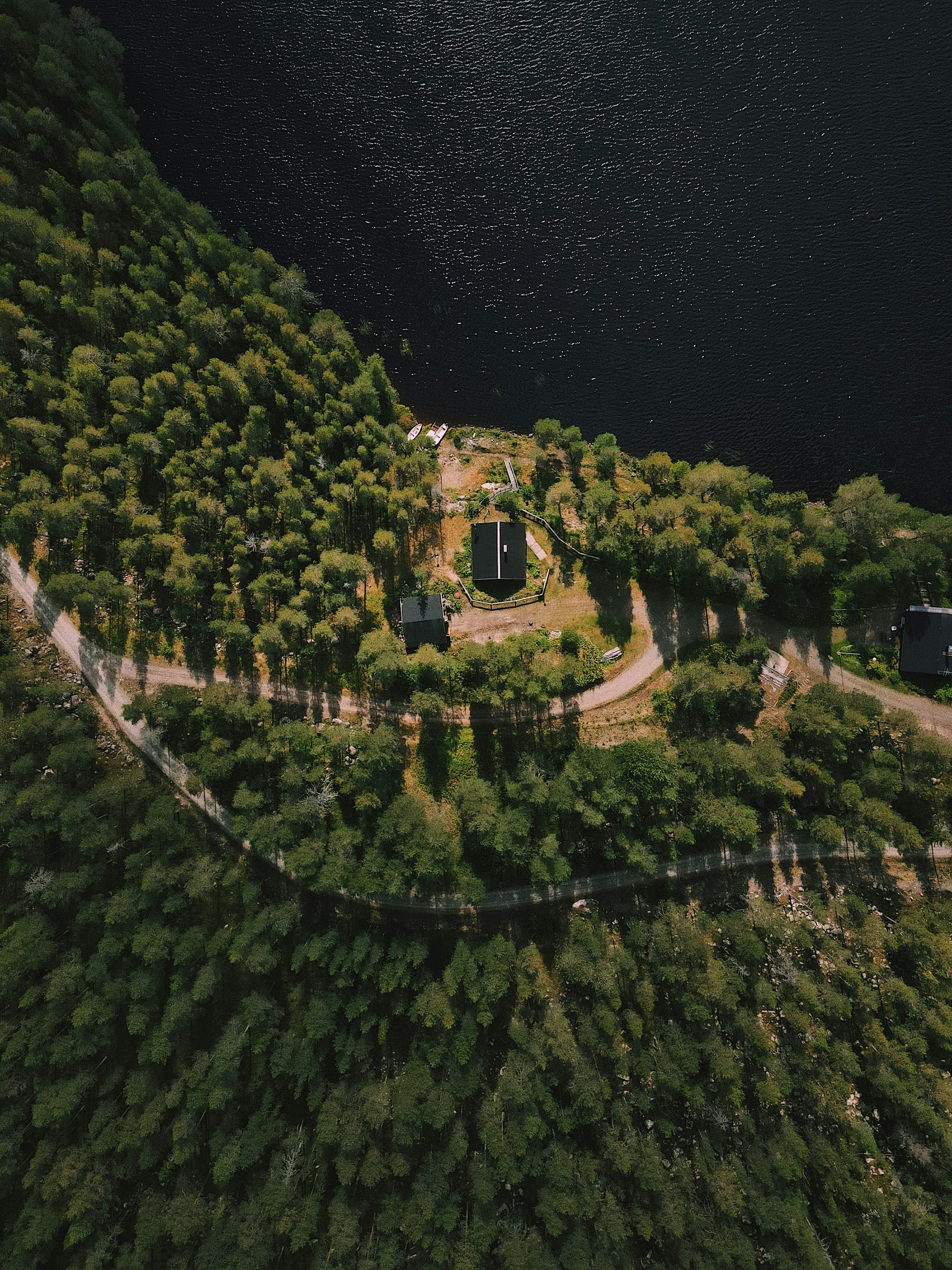 an aerial view of a road surrounded by trees