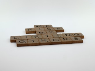 a couple of scrabble tiles sitting on top of a table