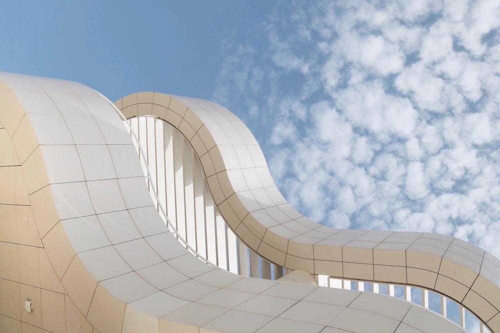 a curved white building with a sky background