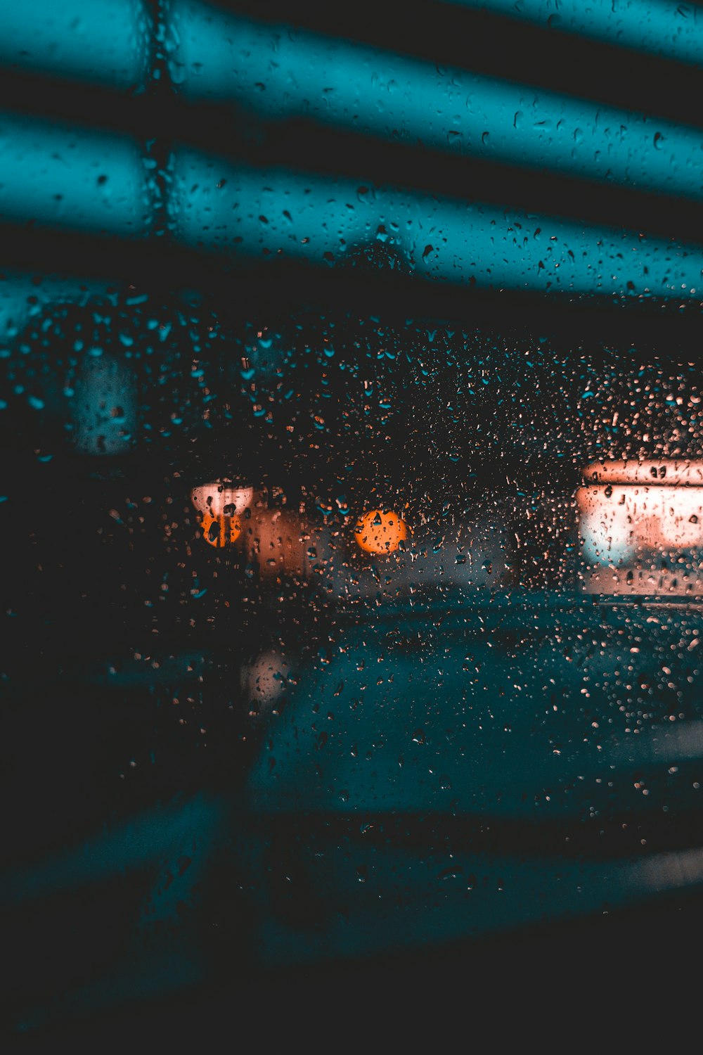 a view of a street through a rain covered window