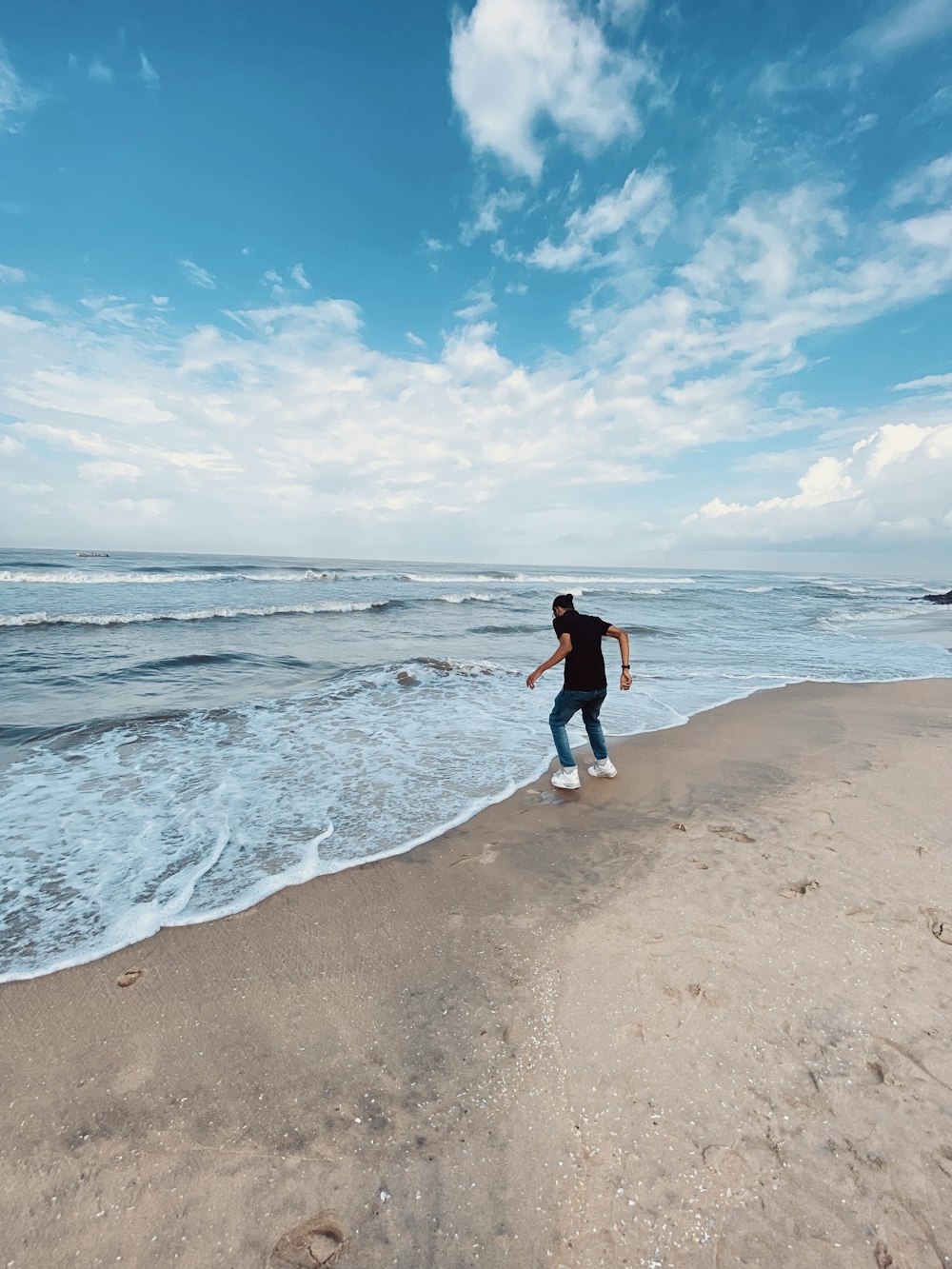 a person running on a beach near the ocean