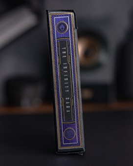 A rectangular box with elegant design elements, featuring a dark color palette with gold accents. The text 'The Infinity Saga' is prominently displayed on the side. The setting appears dark and muted, emphasizing the luxurious feel of the packaging.