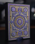 Close-up of a sleek black box with gold foil embossing and intricate patterns.