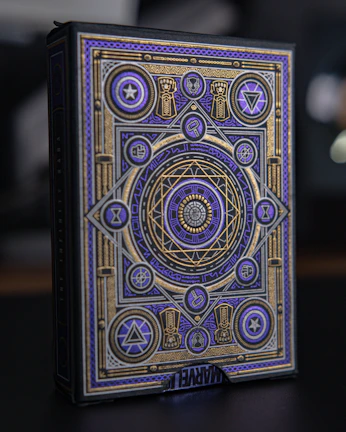 Close-up of a sleek black box with gold foil embossing and intricate patterns.