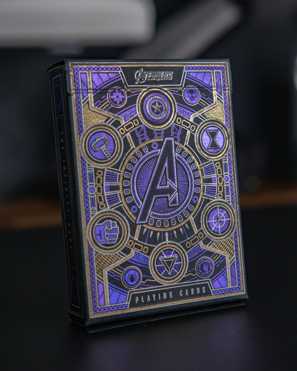 a purple and gold playing card sitting on top of a table