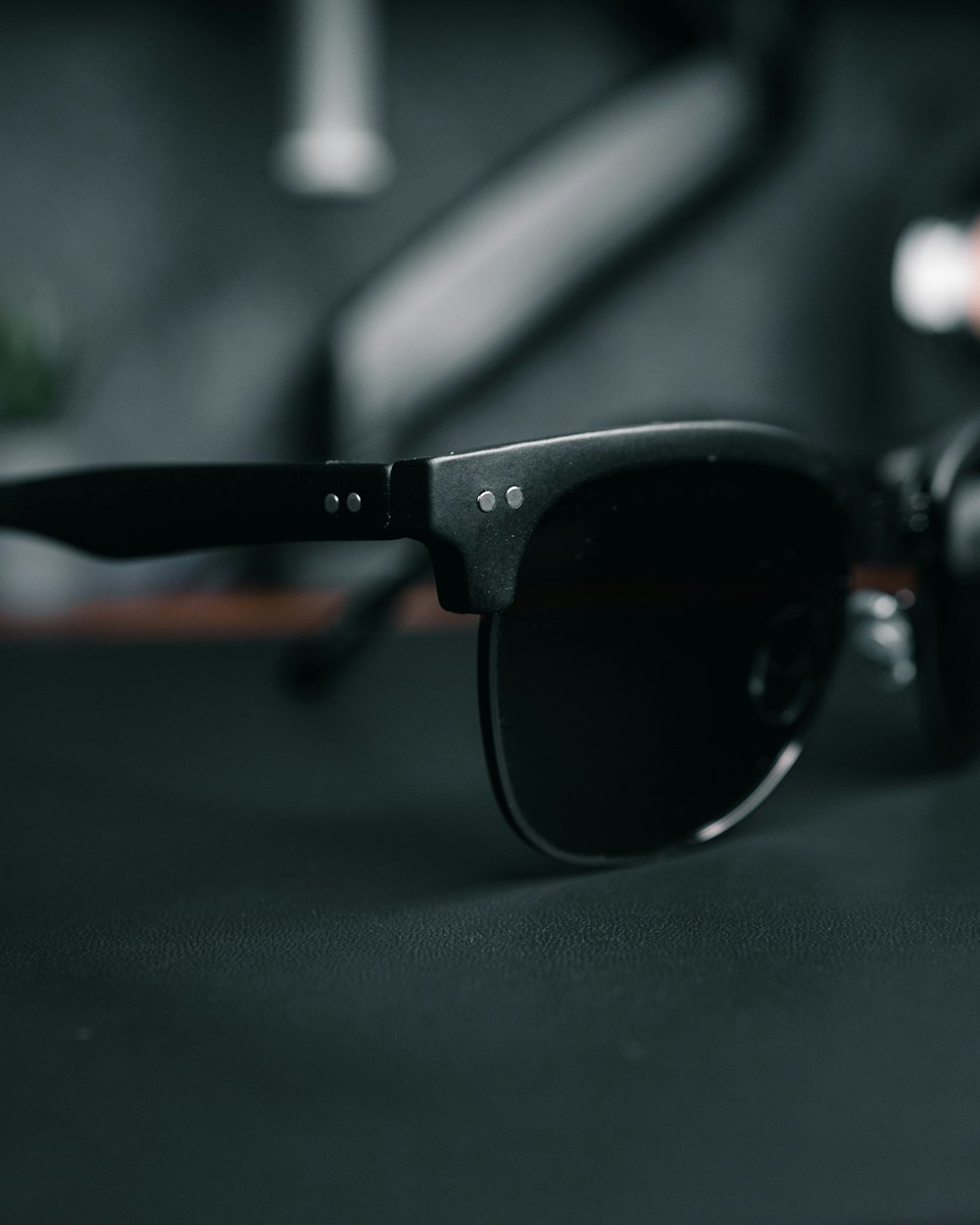 a pair of black sunglasses sitting on top of a table