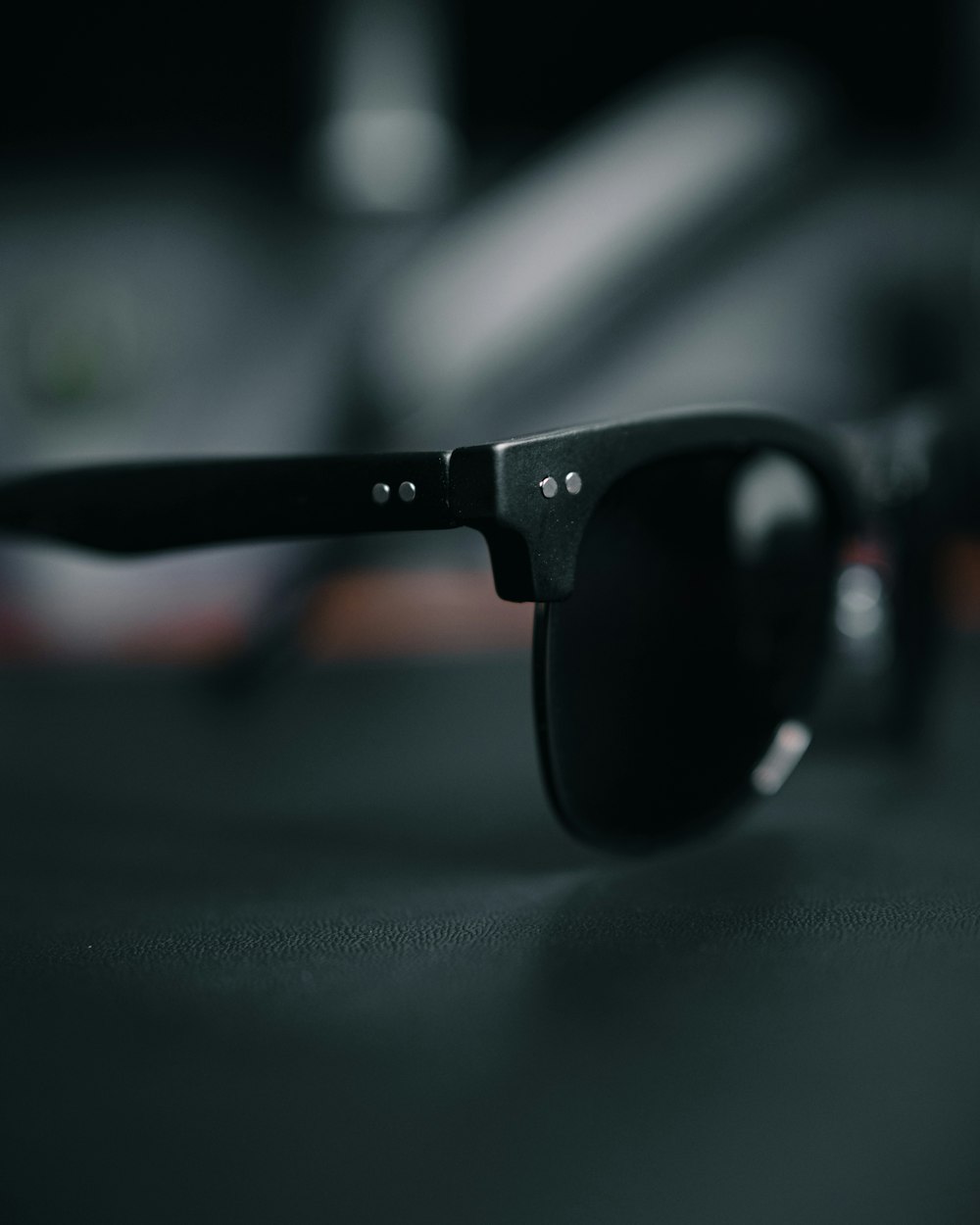 a pair of black sunglasses sitting on top of a table