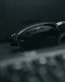 Minimalist shot of stylish sunglasses with a soft shadow on white.