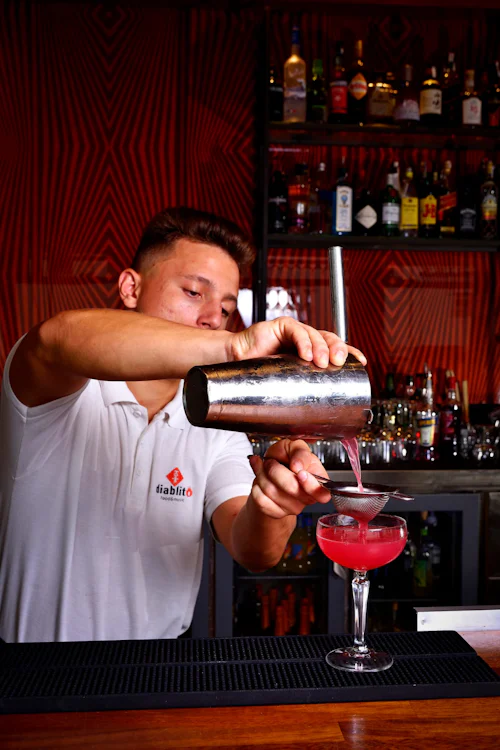 Bartender making a cocktail, representative photo — not the actual venue