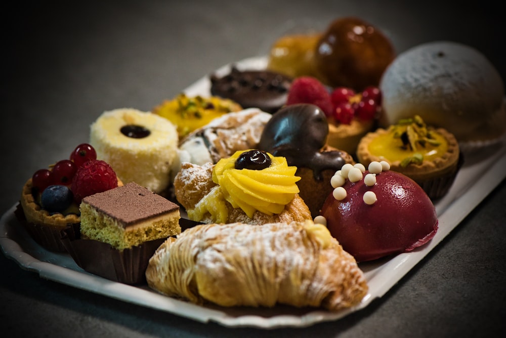 a white plate topped with lots of different types of pastries