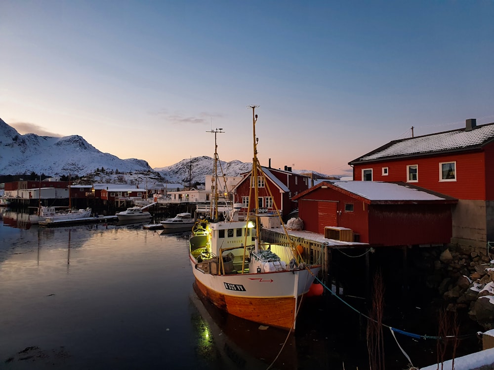 a boat docked in a harbor with a mountain in the background