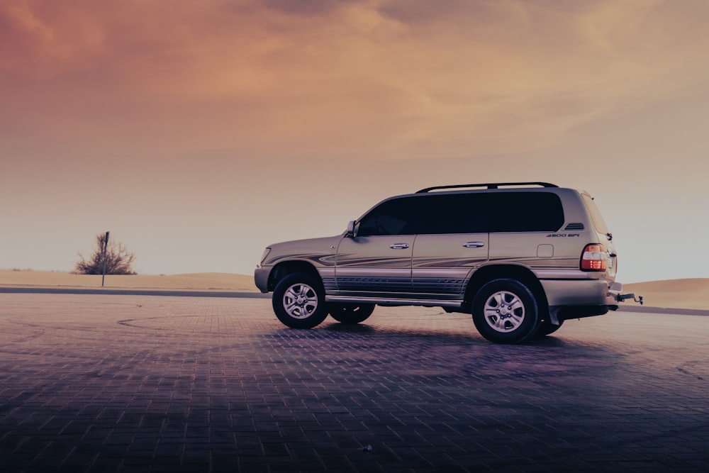 a silver suv parked in a parking lot