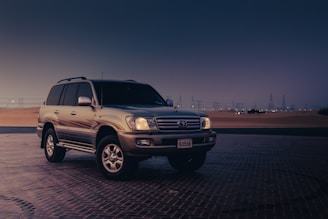a suv parked in a parking lot at night