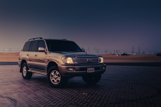 a suv parked in a parking lot at night