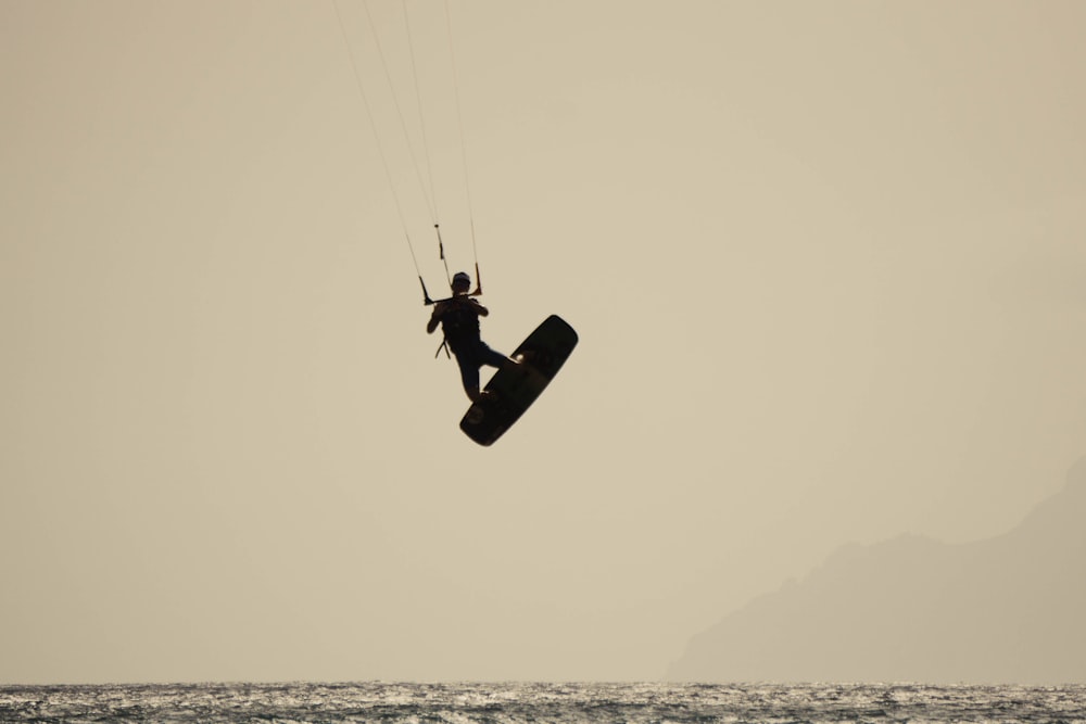 a person riding a kite board in the air