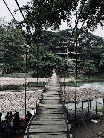 A community coming together to build a modular bridge over a rural river.