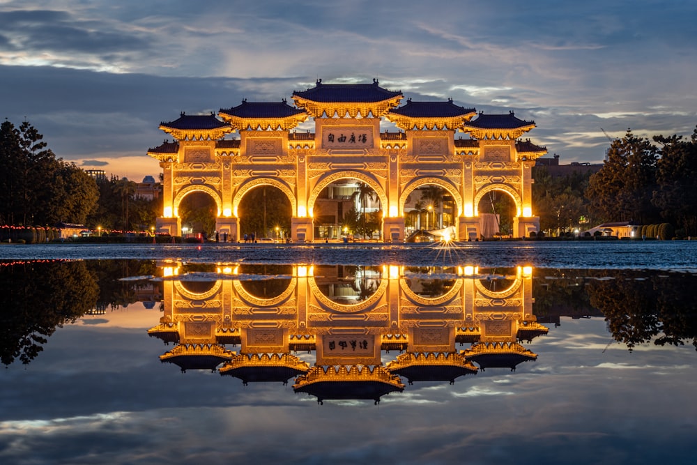 a reflection of a building in a body of water