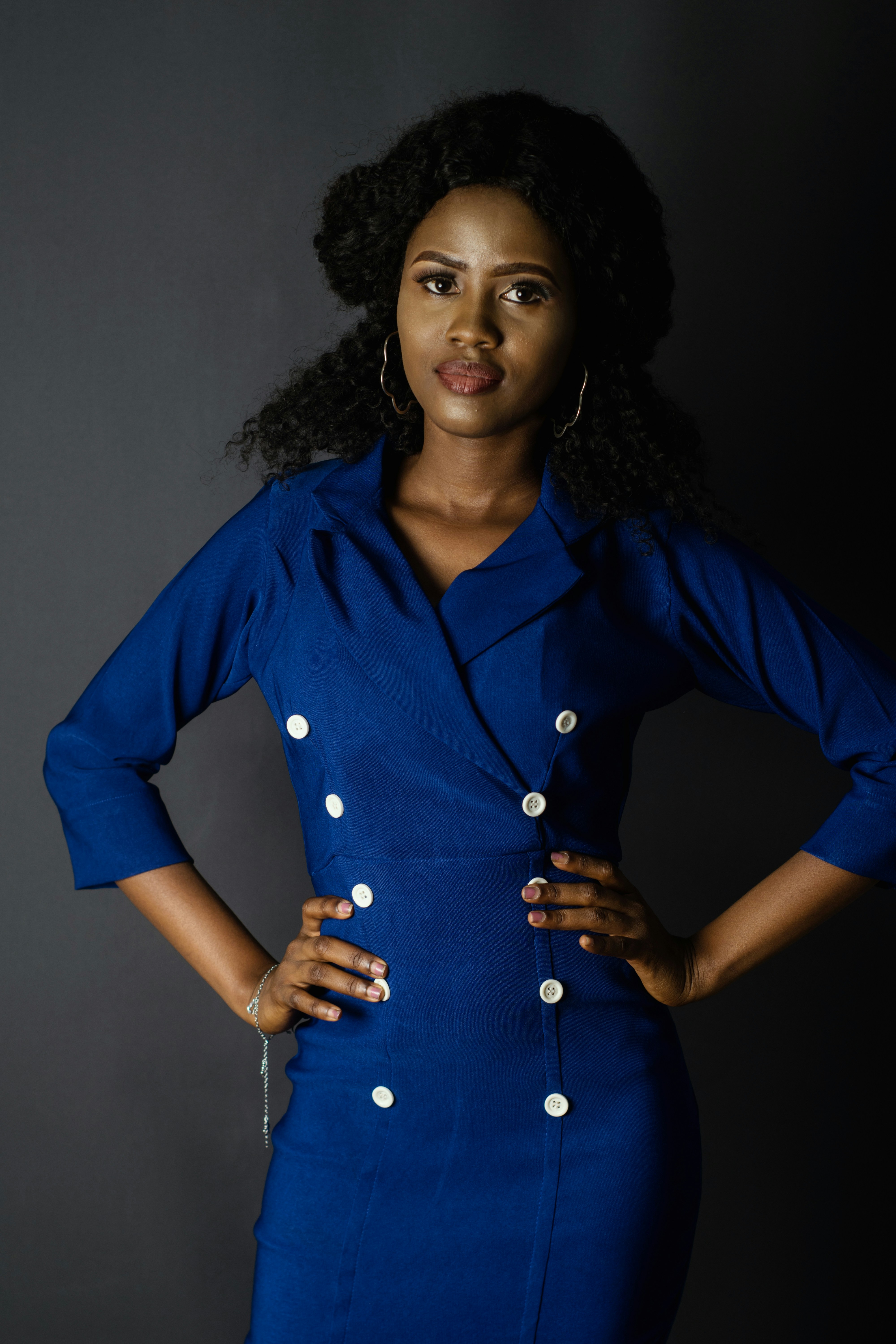 Woman in a blue dress posing for a campaign photograph