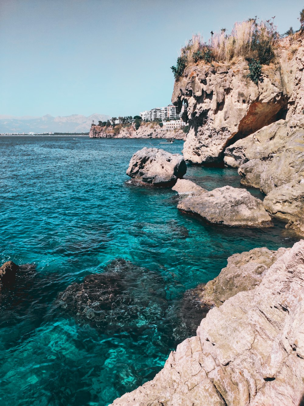 a body of water near a rocky shore