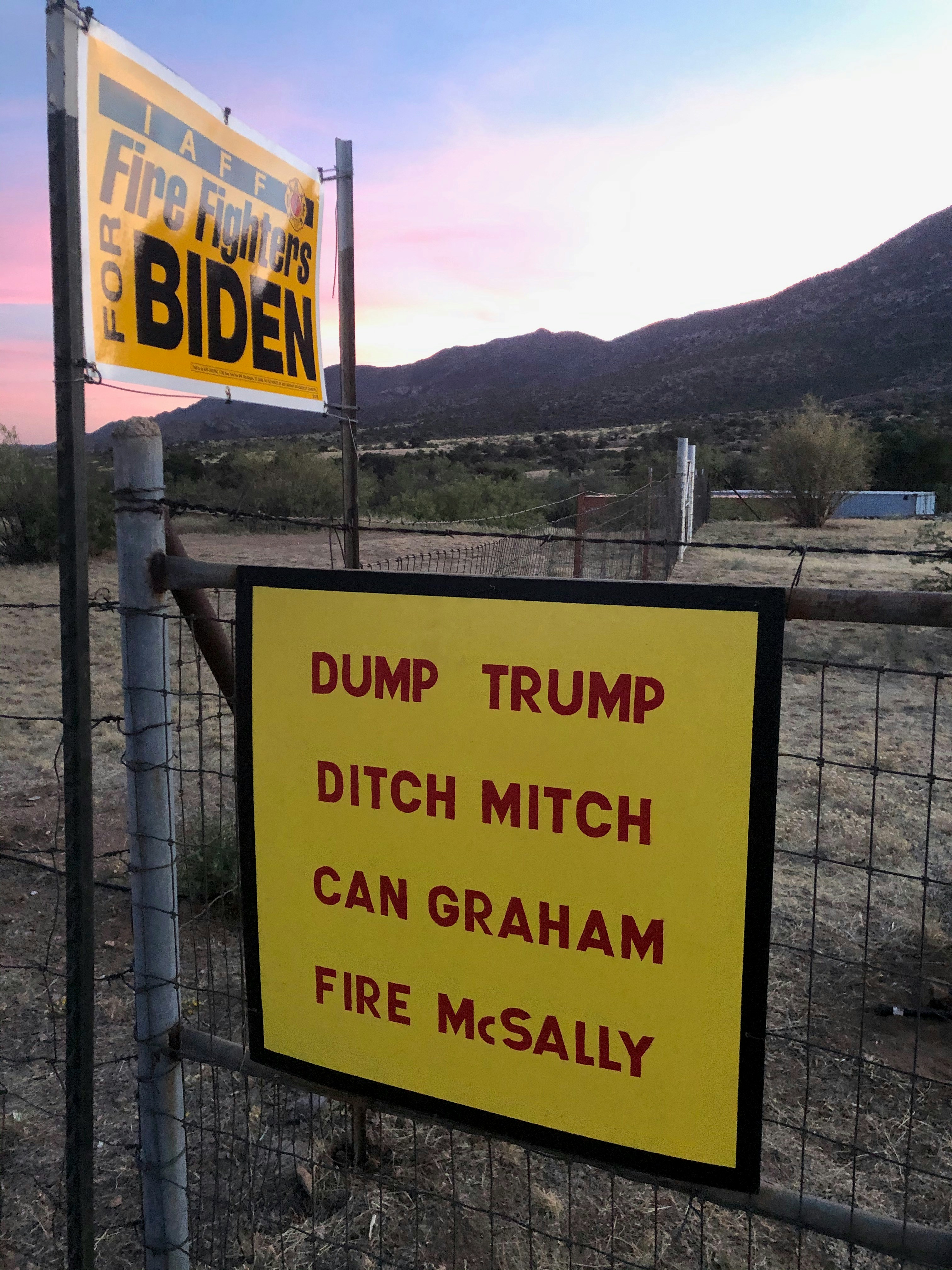a sign on a fence that says dump trump ditch mitchell can graham fire mesal