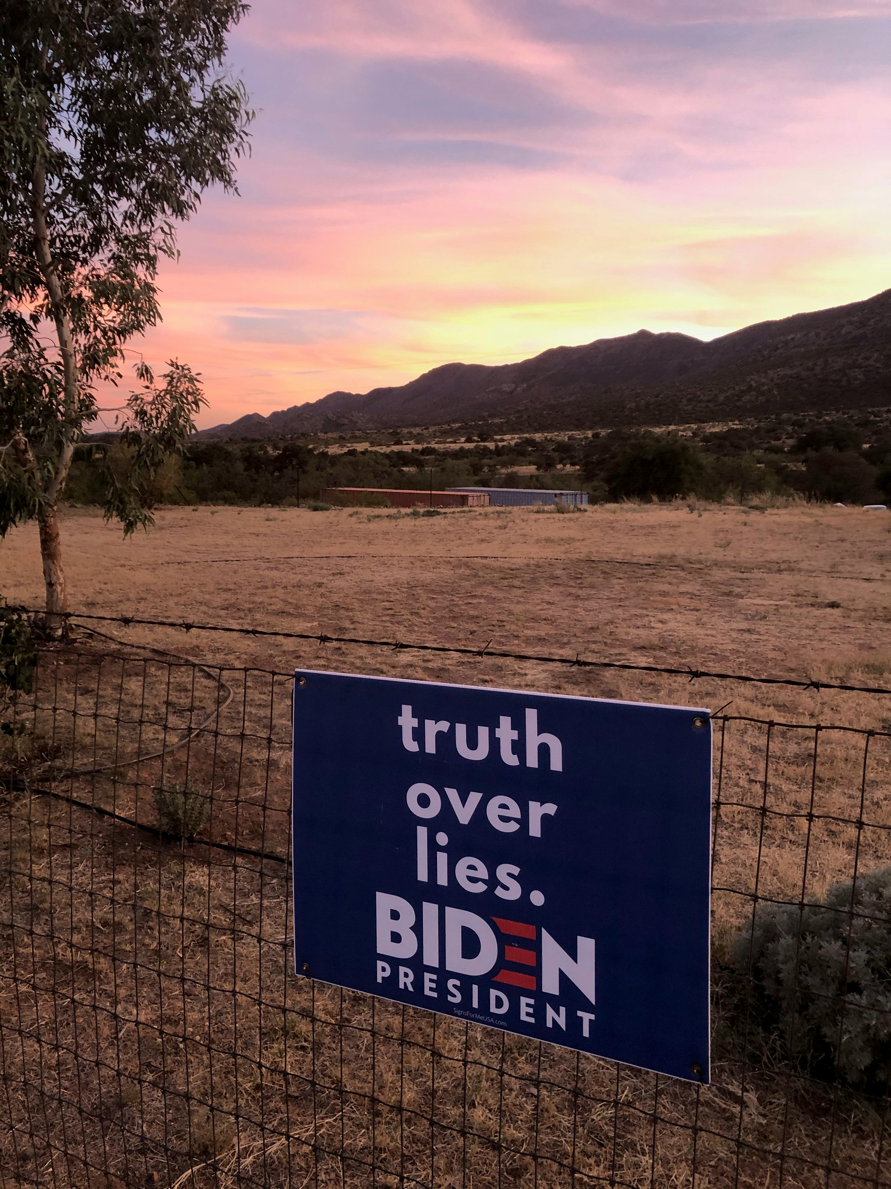 a blue sign that reads truth over lies biden
