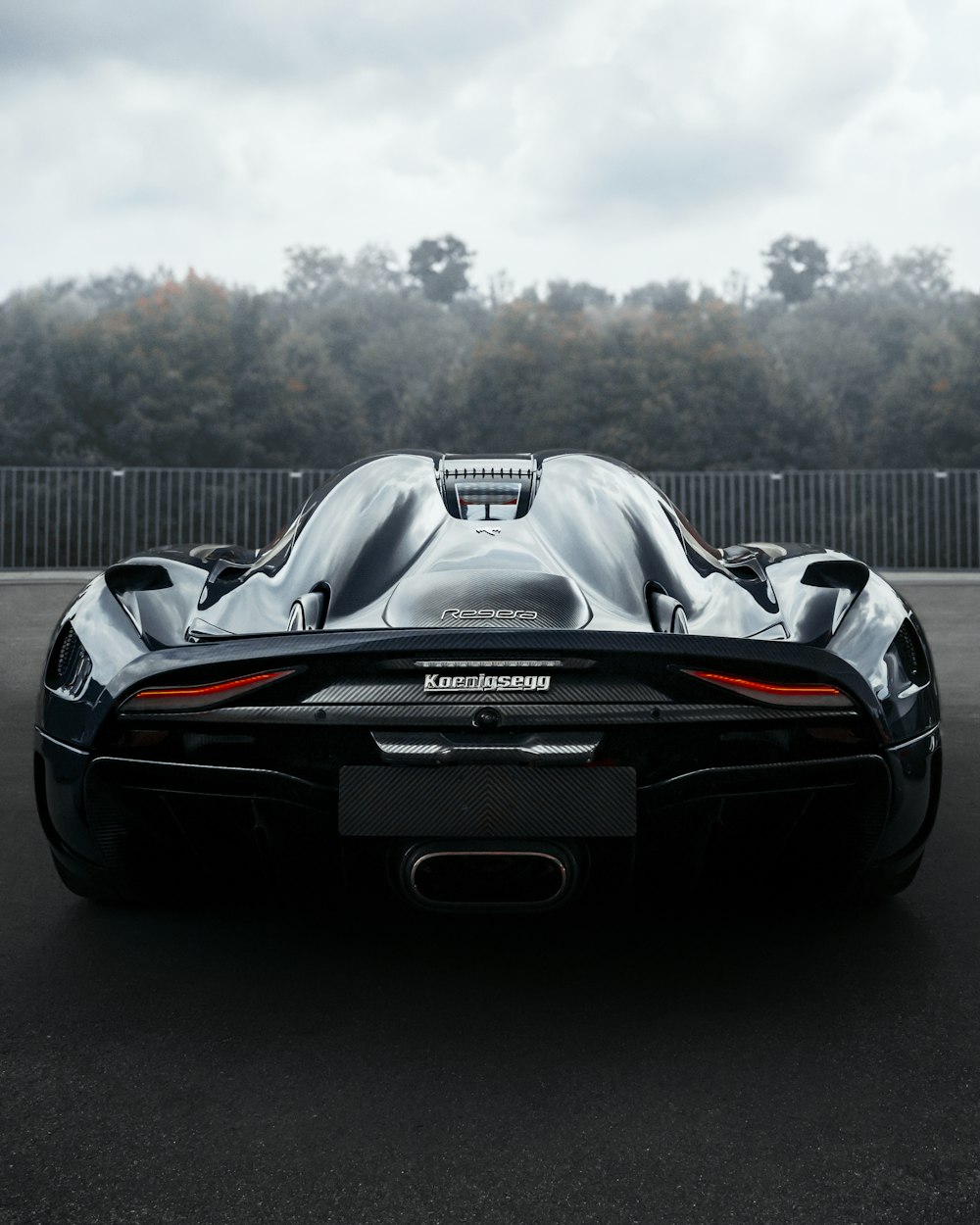 a black sports car driving down a street