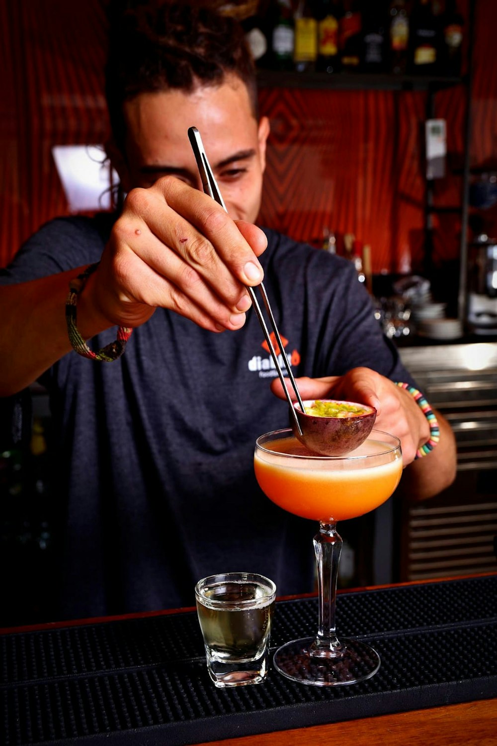 a man is making a drink at a bar