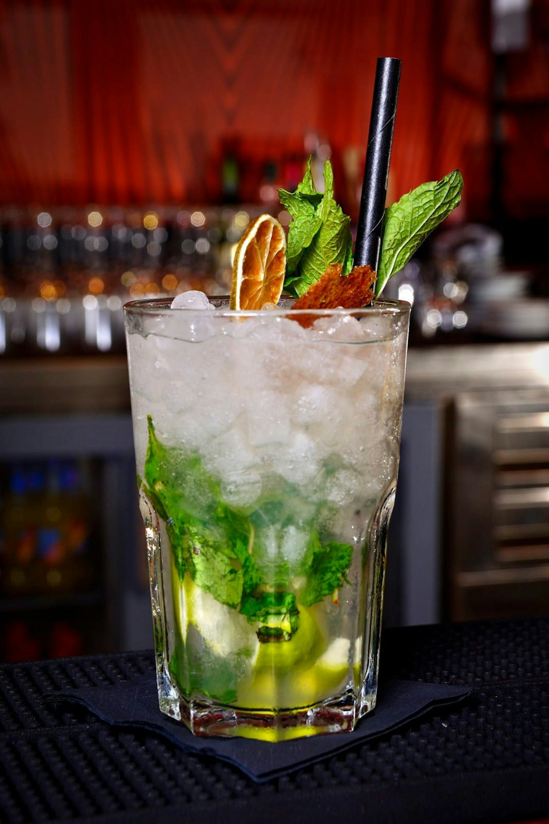 a tall glass filled with ice and mint