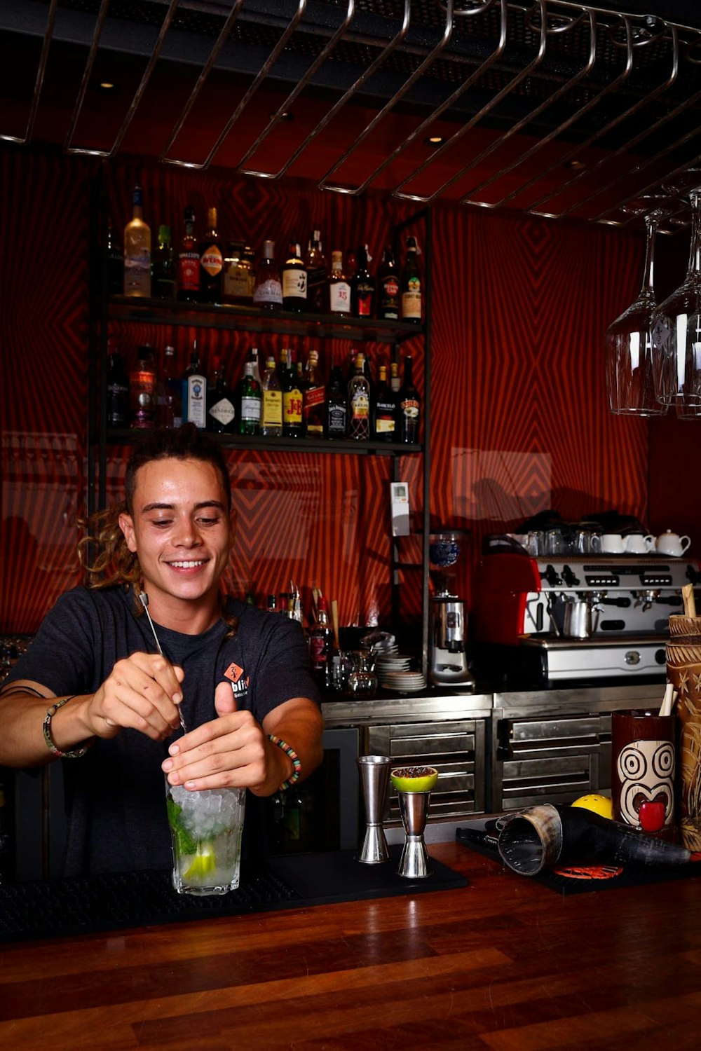 a woman is making a drink at a bar