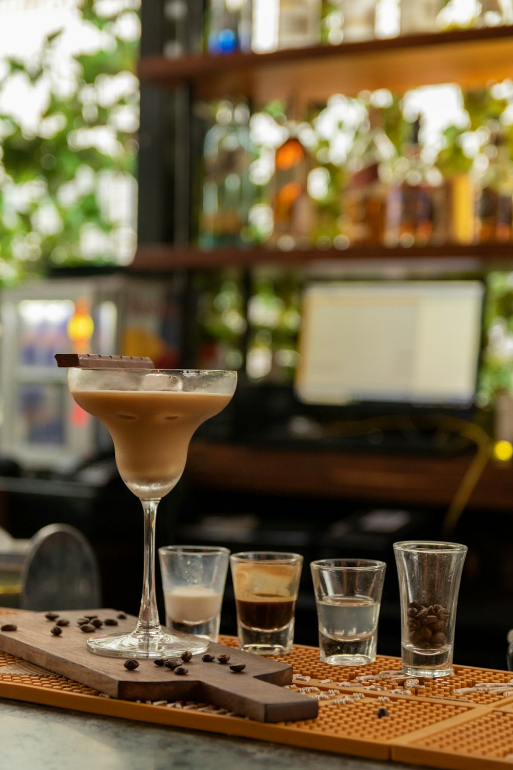 a wooden tray topped with glasses filled with drinks