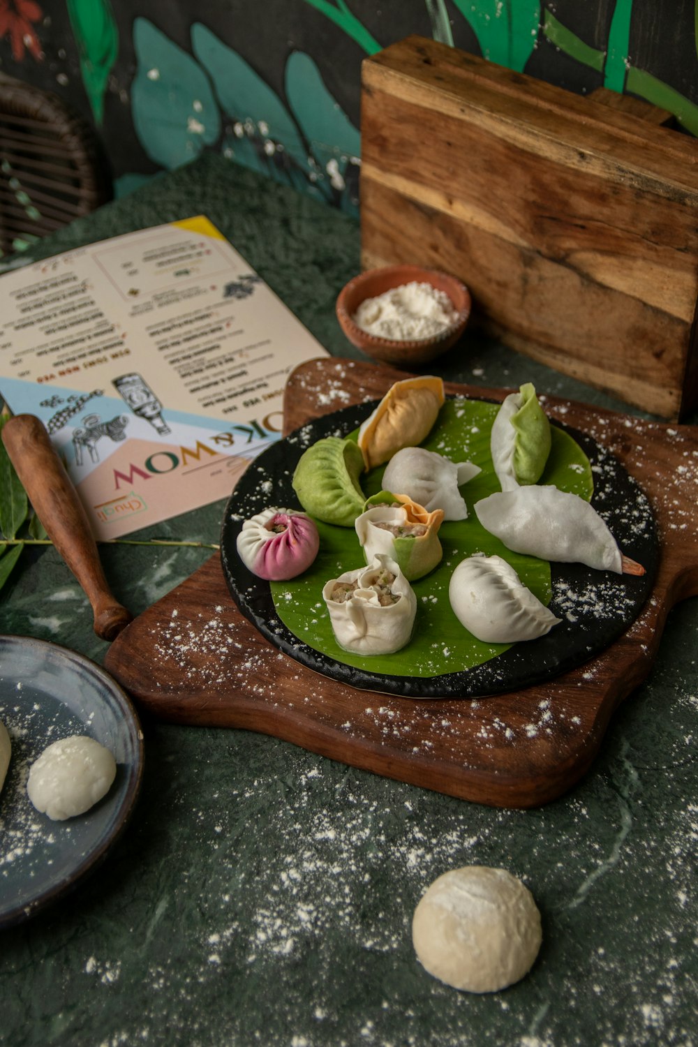 a table topped with plates of food and a menu