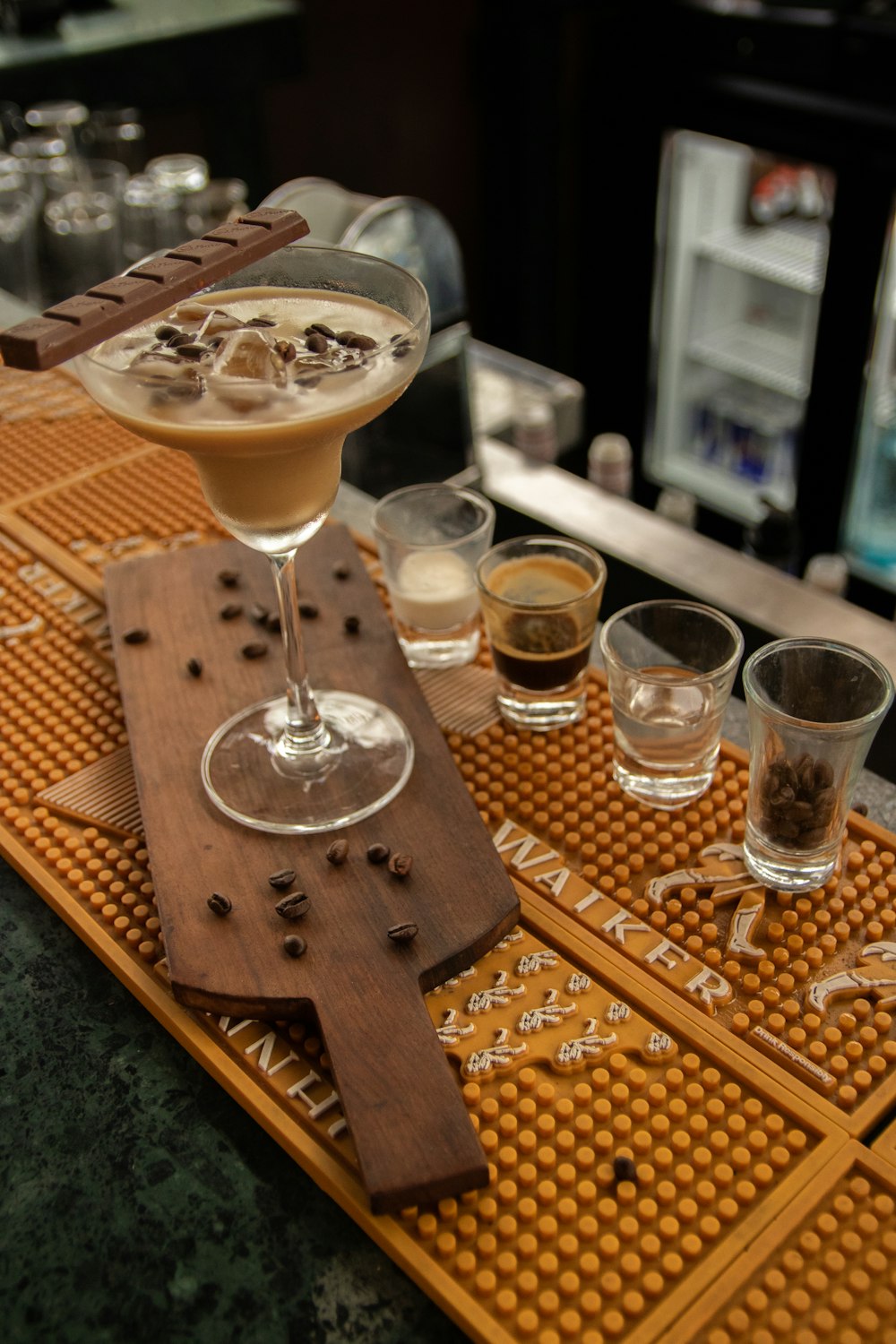 a wooden tray topped with glasses filled with drinks