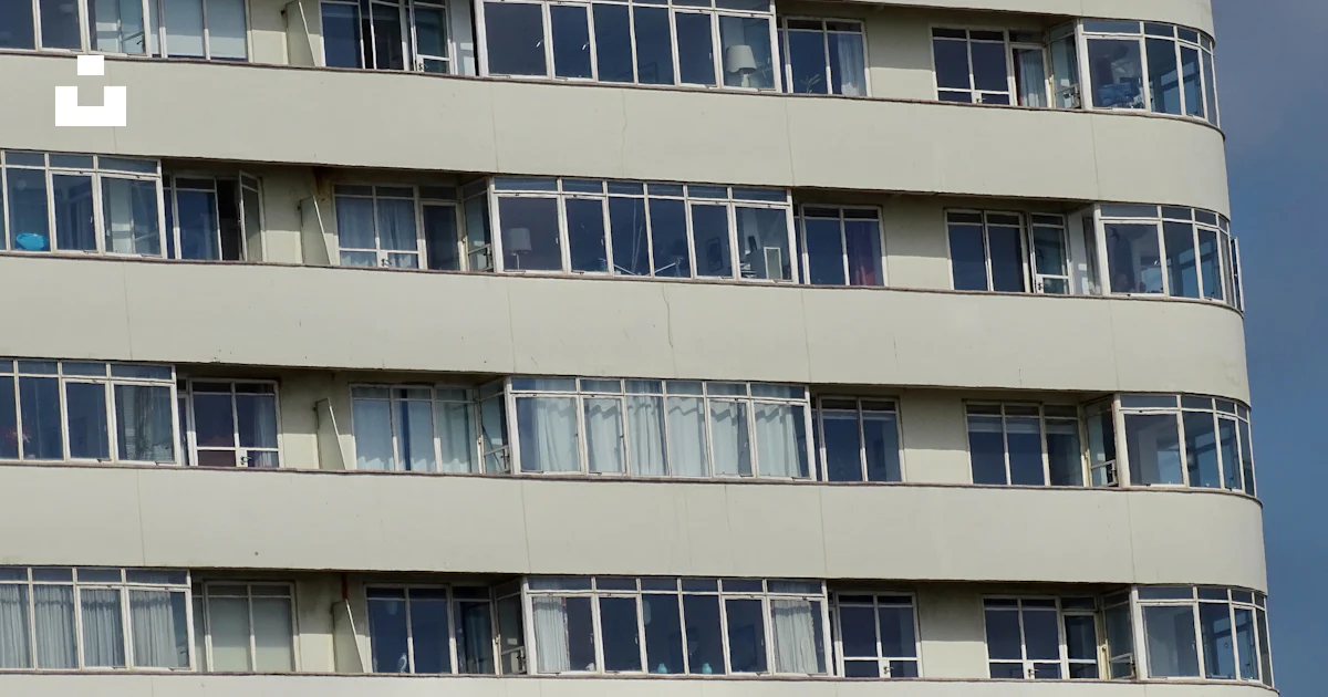 A very tall building with lots of windows photo – Free Windows Image on ...