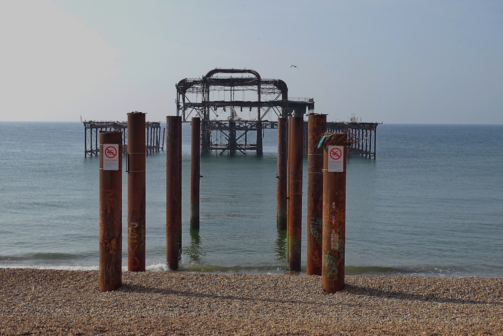 a view of a beach with a pier in the background
